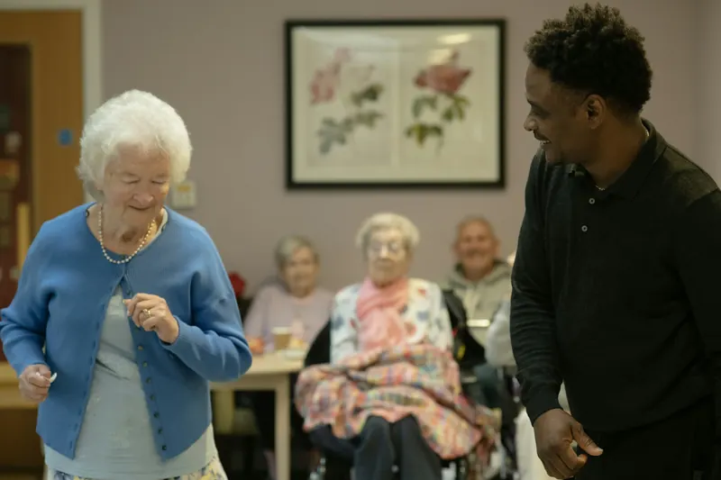 Older adults enjoying music in a community room