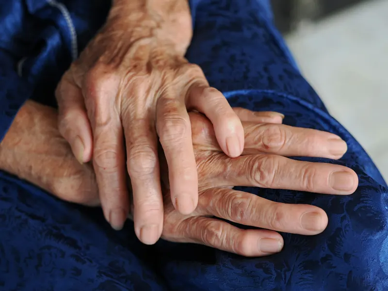 Older person's hands resting together