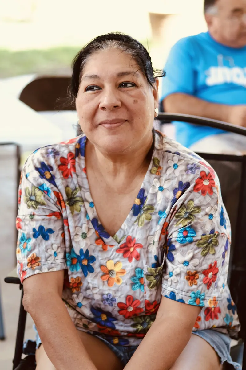 Smiling older woman in a floral blouse