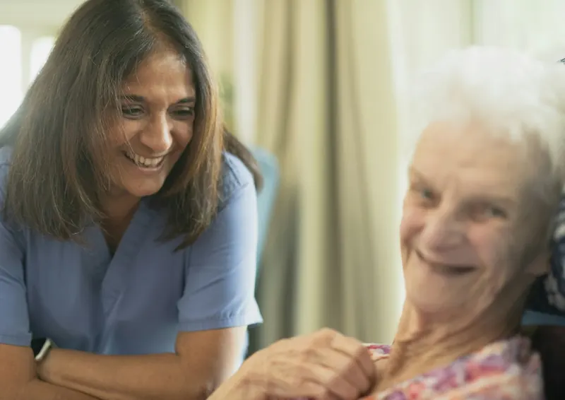 Nurse smiling with an older woman